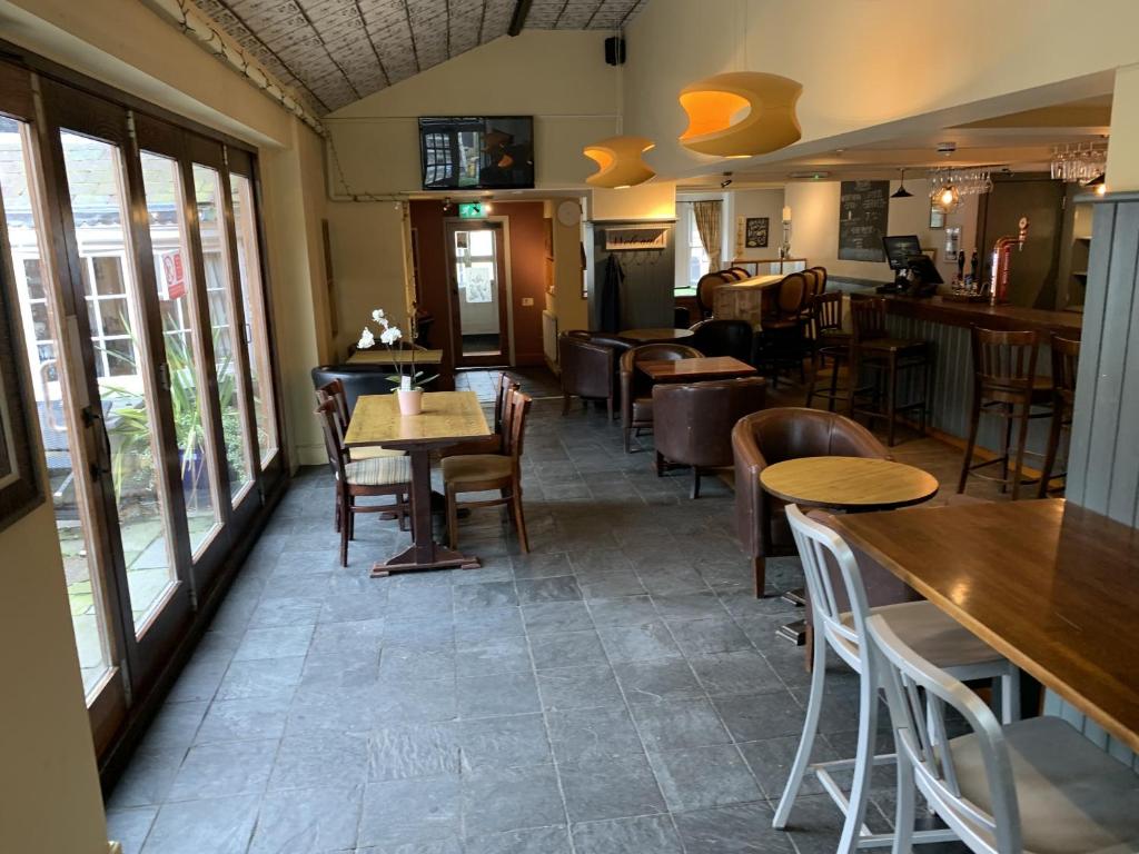 a restaurant with tables and chairs in a room at George and Dragon in Tarvin