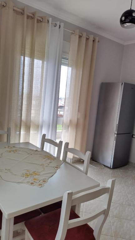 a kitchen with a white table and a refrigerator at Luxury vila in Babru