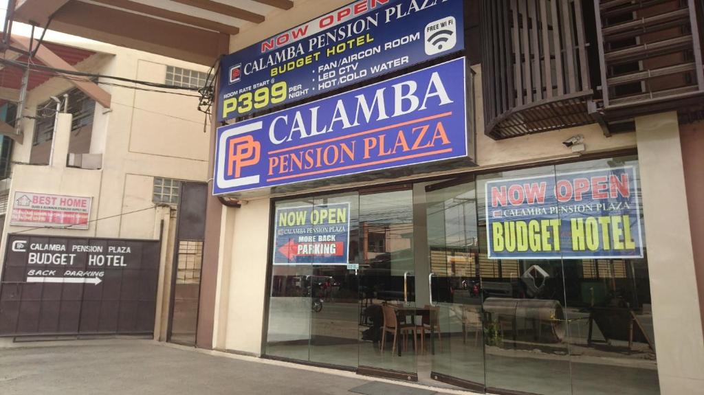 a store with signs on the side of a building at Calamba Pension Plaza in Calamba