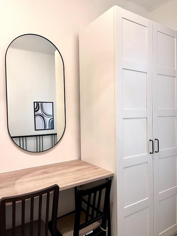 a dressing room with a mirror and a wooden table at Quiet apartment close to center in Prague