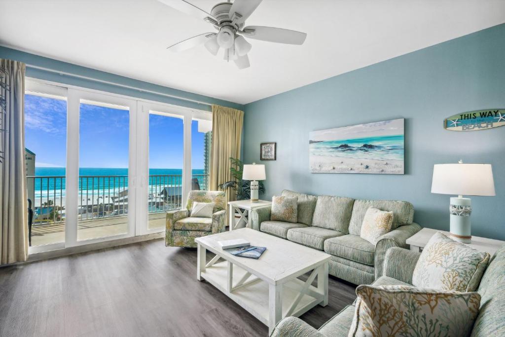 a living room with a view of the ocean at Laketown Wharf #824 by Nautical Properties in Panama City Beach