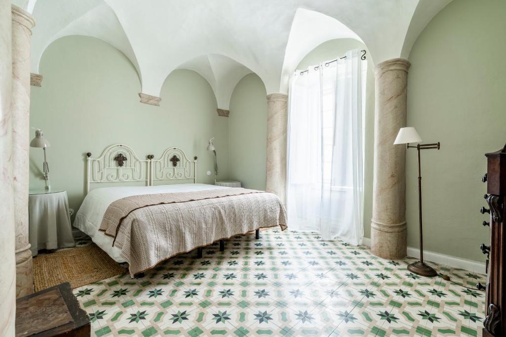 a bedroom with a bed and a large window at Casa Garcia in Amareleja