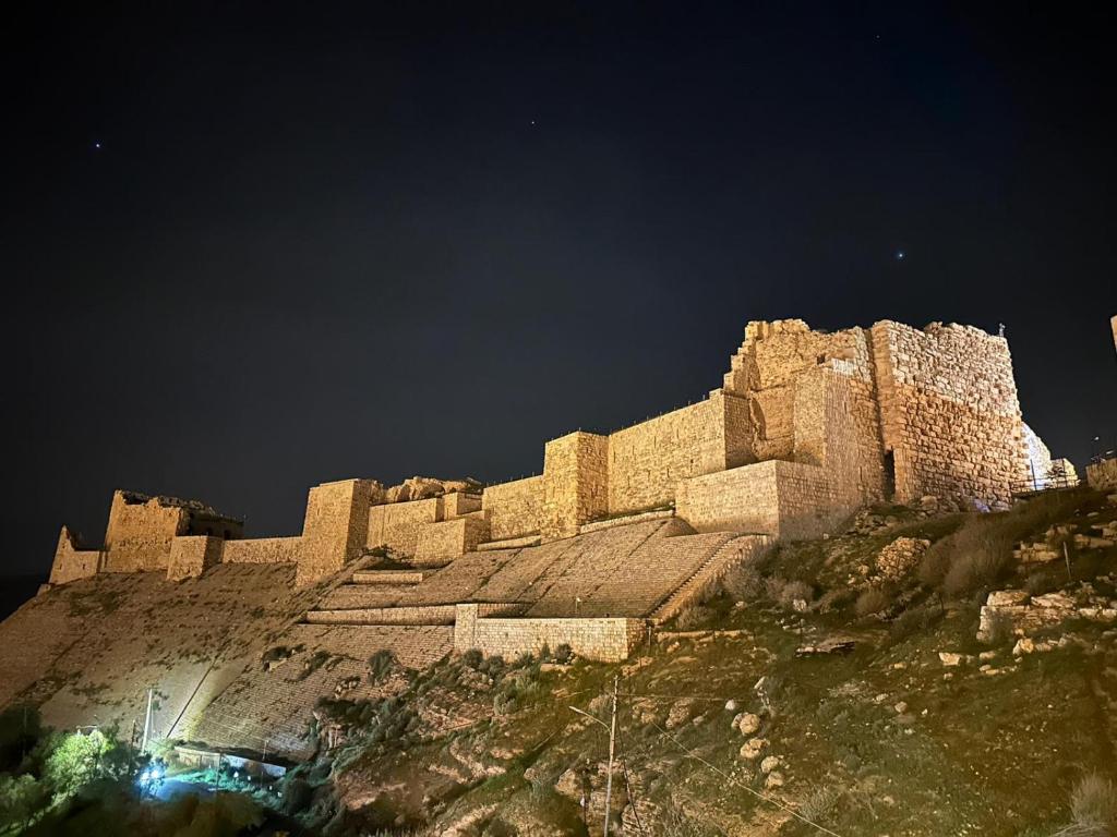 a castle on top of a mountain at night at the old house in Kerak