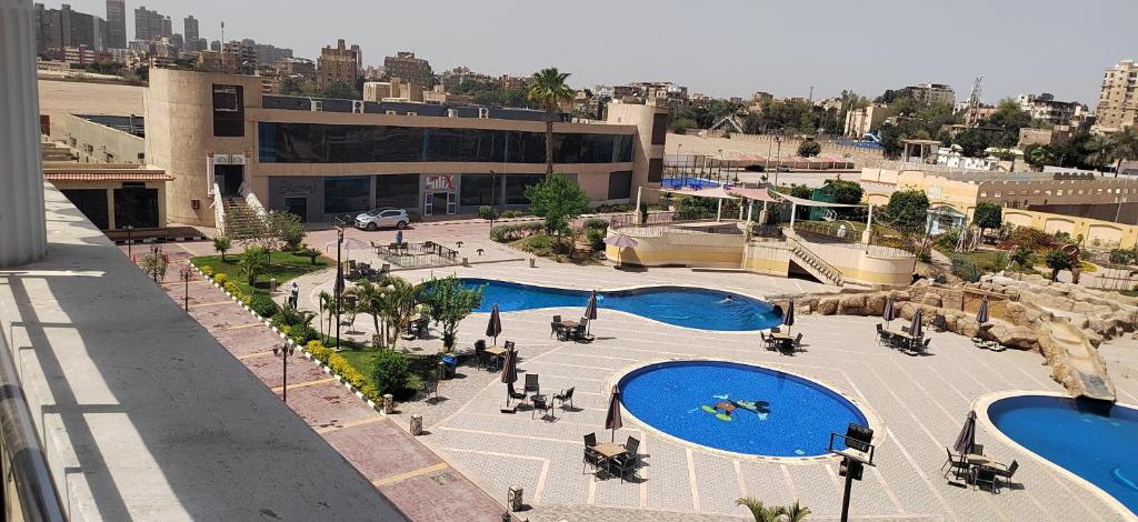 an overhead view of a building with two swimming pools at Loaloat maadi Hostel "Cornich Elnile" in Cairo