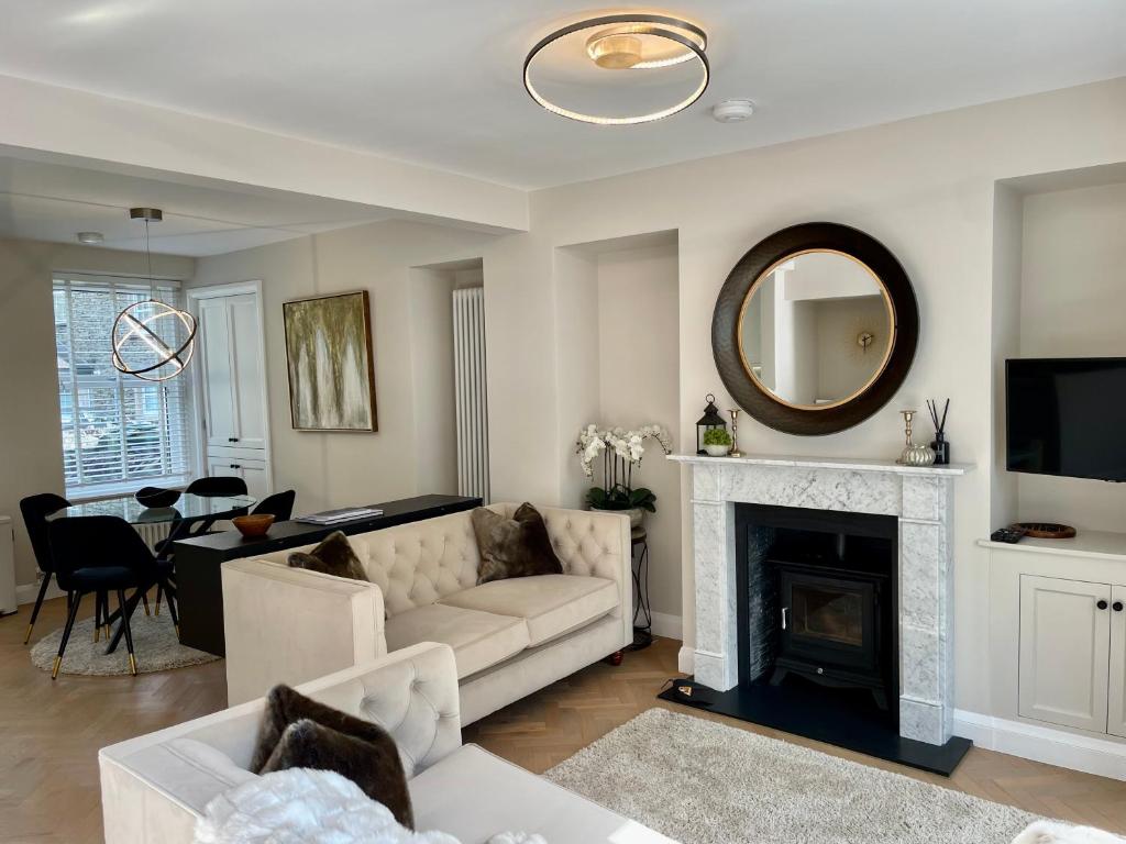 a living room with a couch and a fireplace at Heather Mere Cottage, Bowness-on-Windermere in Bowness-on-Windermere