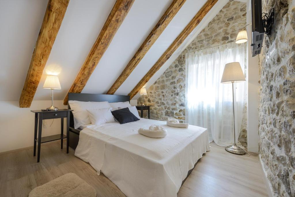 a bedroom with a large white bed in a room at Luxury Deluxe Apartment in Dubrovnik