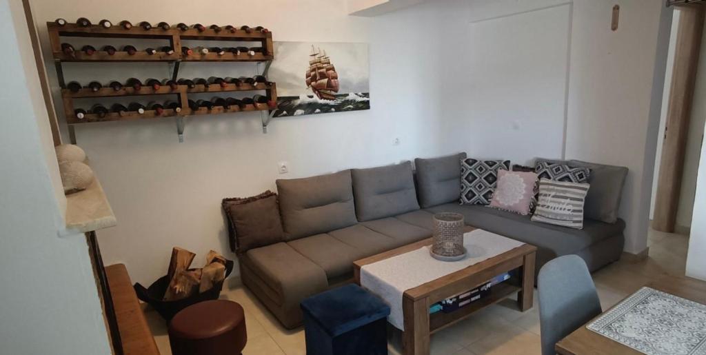 a living room with a couch and a table at Bouvegio Apartments Giorgos in Afantou