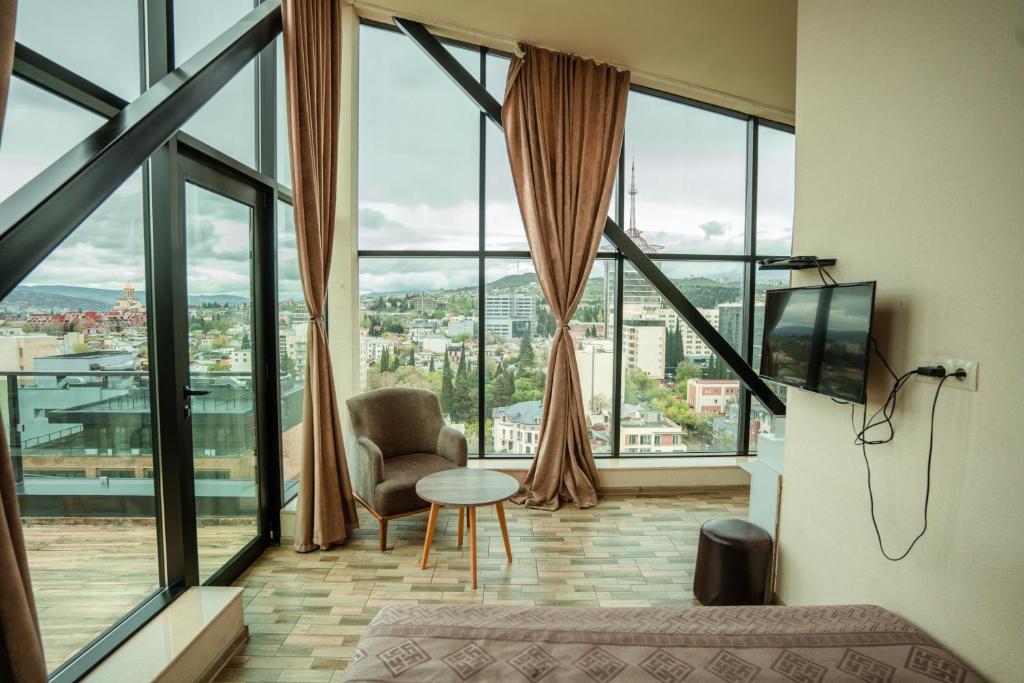 a living room with a view of a city at Hotel Grand View in Tbilisi in Tbilisi City