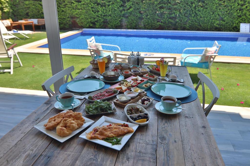 a wooden table with food on top of it at Alacaat Otel in Alaçatı