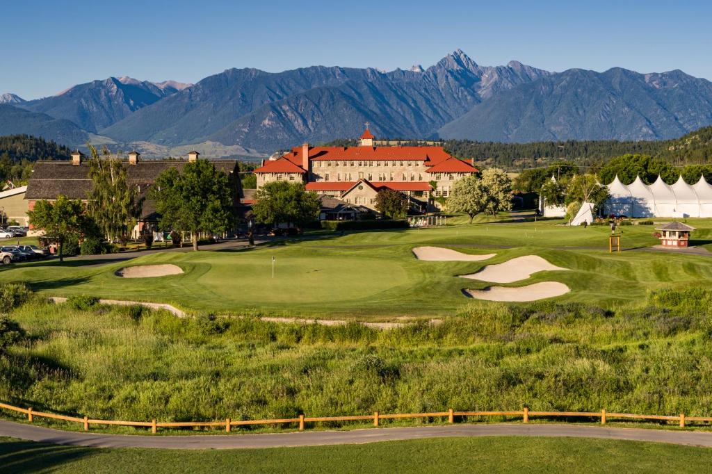 a view of a golf course with mountains in the background at St. Eugene Golf Resort & Casino in Cranbrook