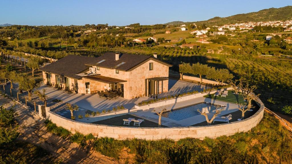an aerial view of a house with a swimming pool at Alto do Ferrum - Boutique Villa in Covilhã