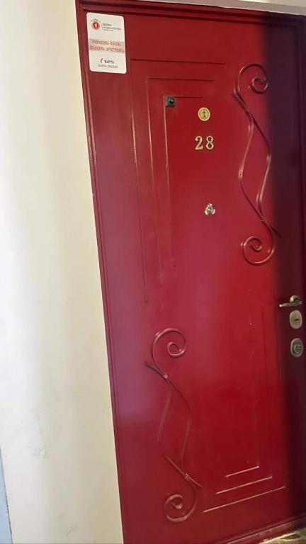 a red door with the number on it at GT HOME in Tbilisi City