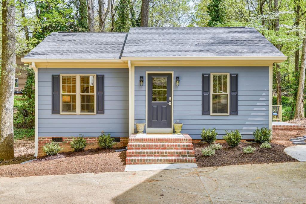 a small blue house with a blue door at Beautiful Raleigh Cottage Rental 5 Mi to Downtown in Raleigh