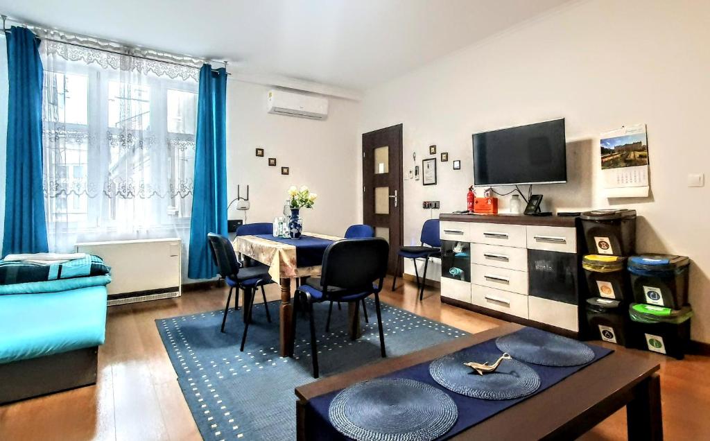 a living room with a table and a dining room at GAJ Apartment - Air condition - Free Parking in Krakow
