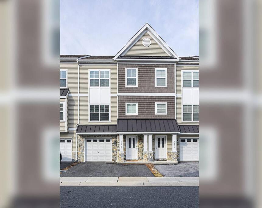 a large brick house with two garages at Rehoboth Crossing - Beach Oasis! in Rehoboth Beach