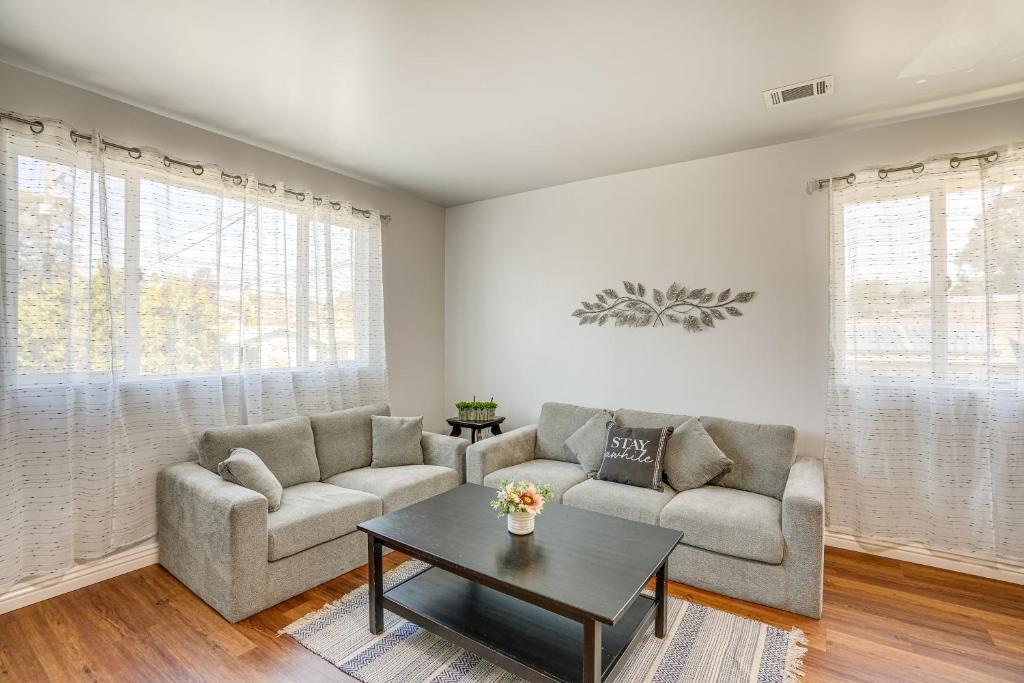 a living room with two couches and a coffee table at Sunny Oakland Vacation Rental - 6 Mi to Downtown in Oakland