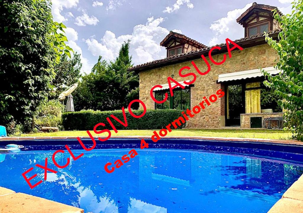 a house with a swimming pool in front of it at Casa rural Paraje de Yuste in Cuacos de Yuste