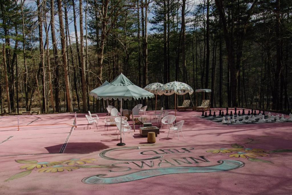 an outdoor event with chairs and umbrellas in the woods at Camp Swann in Tracy City