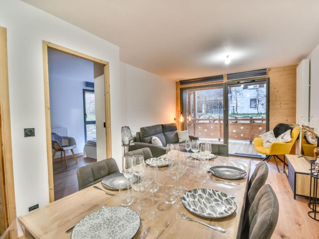 a dining room and living room with a table and chairs at Appartement Les Gets, 3 pièces, 6 personnes - FR-1-685-65 in Les Gets