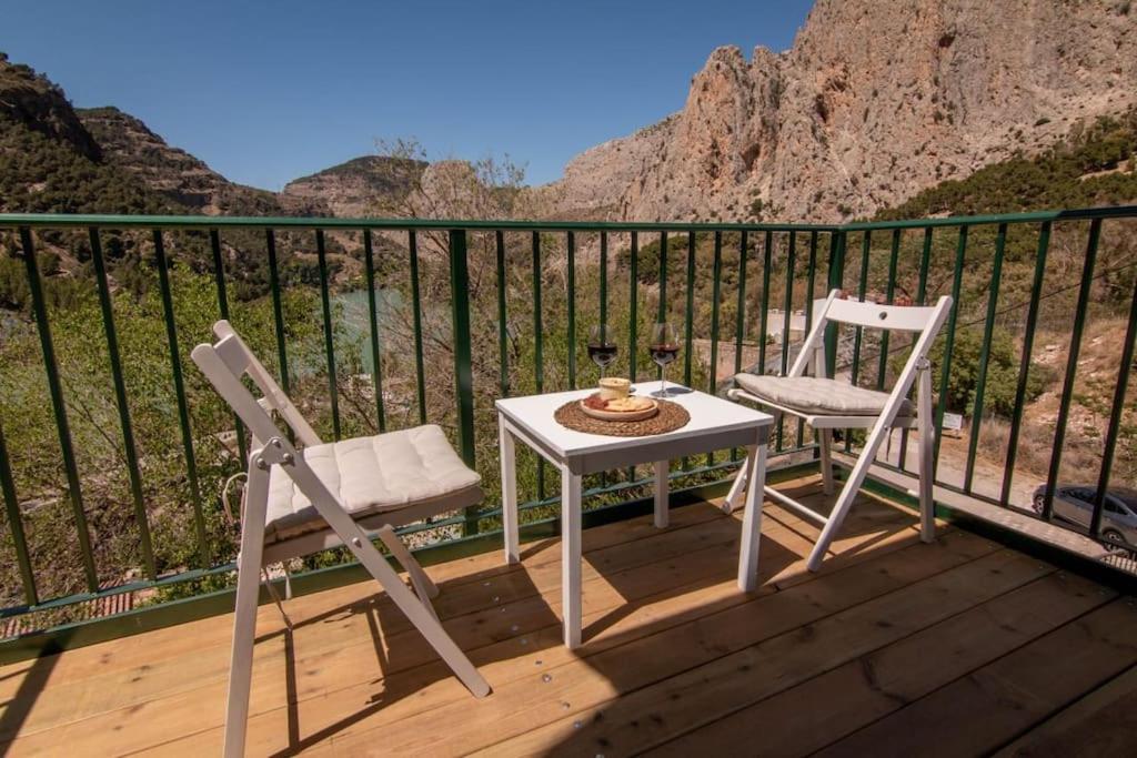 a table and two chairs on a deck with a view at La Barbería de Miguel in El Chorro