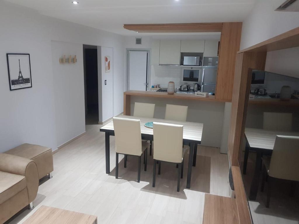 a kitchen and dining room with a table and chairs at Altos de Mendoza II in Las Heras