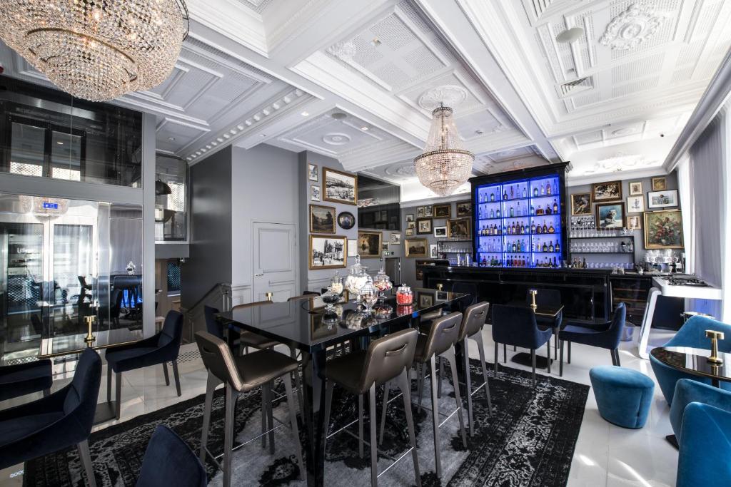 a dining room with a table and chairs and a television at Vertigo Hotel, By Marriott, a Member of Design Hotels in Dijon