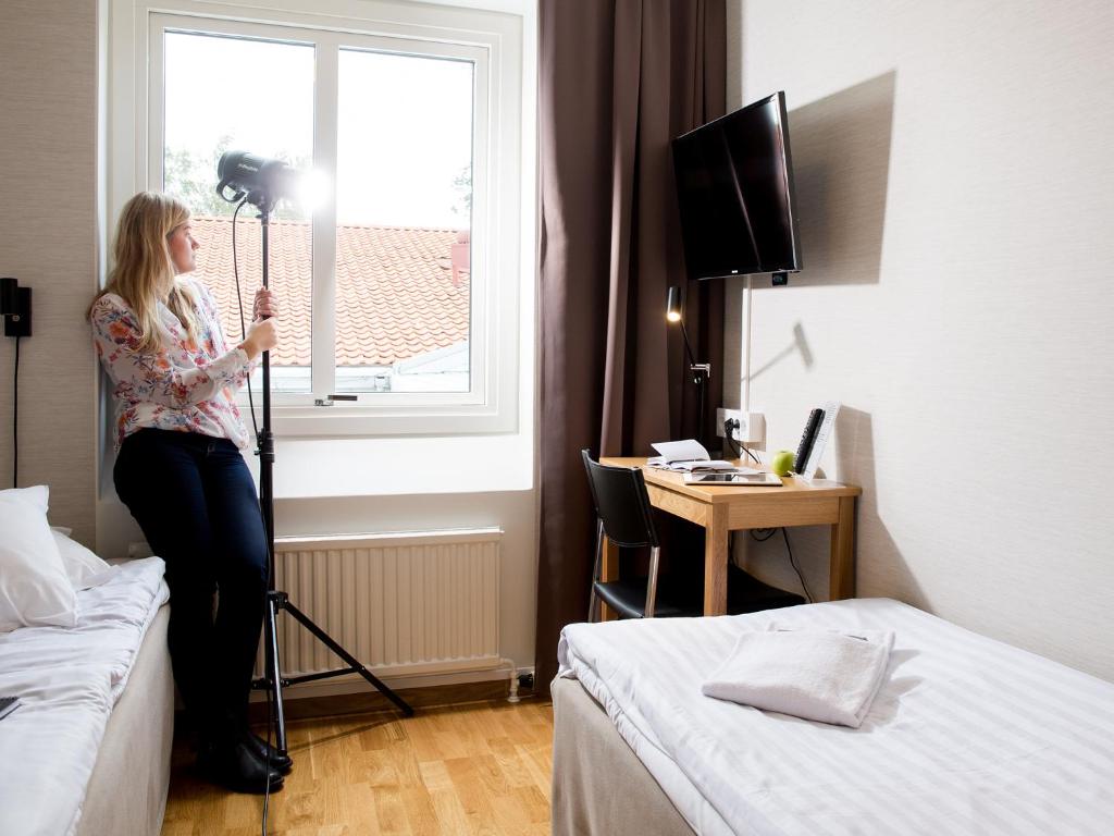 Postel nebo postele na pokoji v ubytování Hotell Svanen