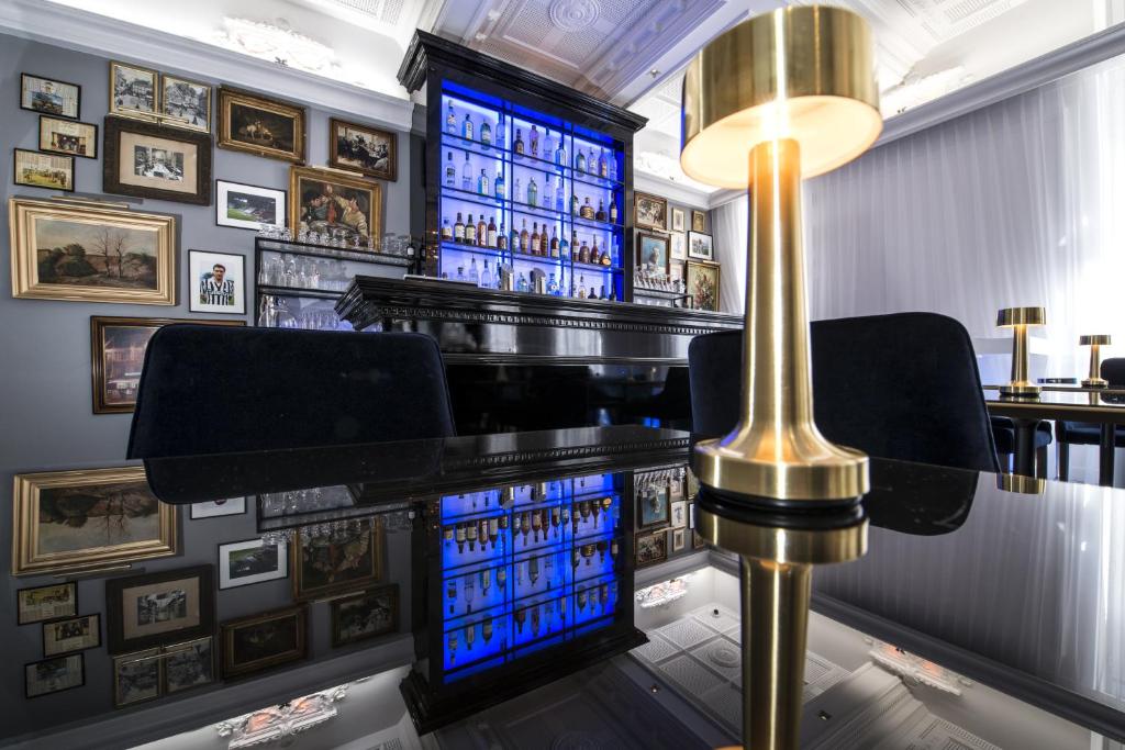 a bar with blue lighting and a table and chairs at Vertigo Hotel, By Marriott, a Member of Design Hotels in Dijon