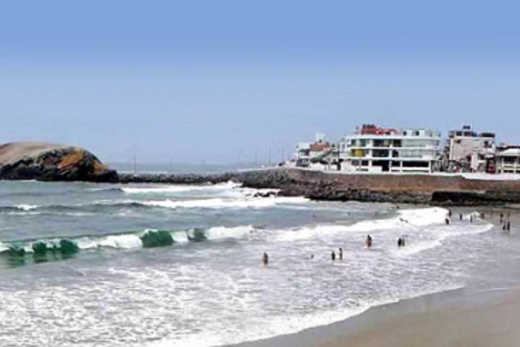 a group of people in the water at the beach at J&B Aparment 2 Punta Hermosa in Punta Hermosa