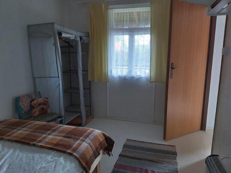 a bedroom with a bed and a sliding glass door at Siedlisko Urszulanka in Policzna