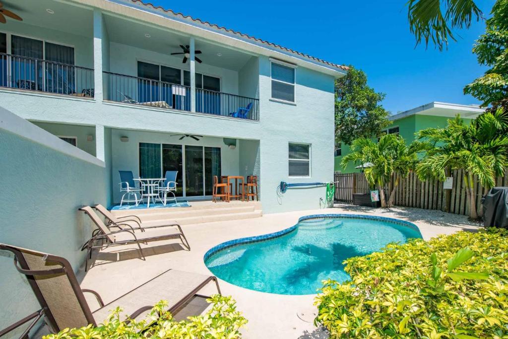 a villa with a swimming pool and a house at Tarpon Villa in Siesta Key