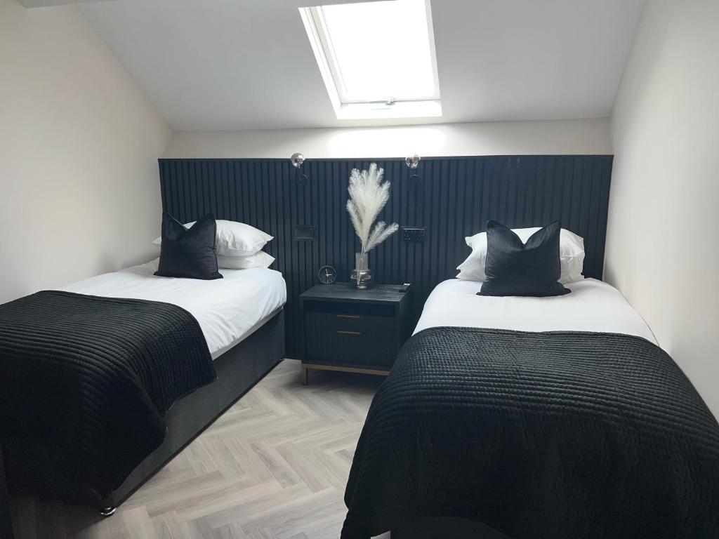 two beds in a room with black and white at 128 Anfield Road in Liverpool