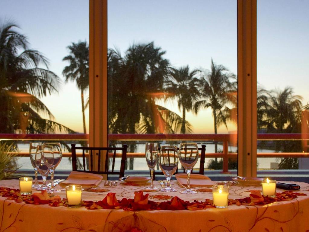 a table with candles and wine glasses on it at Pullman Miami Airport in Miami