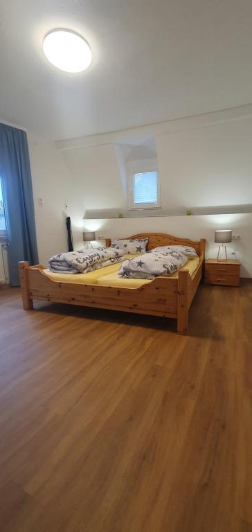 two beds in a room with a wooden floor at Ferienhaus Sonni in Boppard