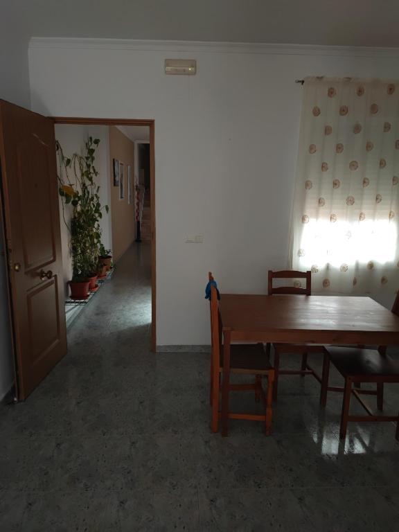 a dining room with a table and chairs and a hallway at Centro Isla Cristina in Isla Cristina