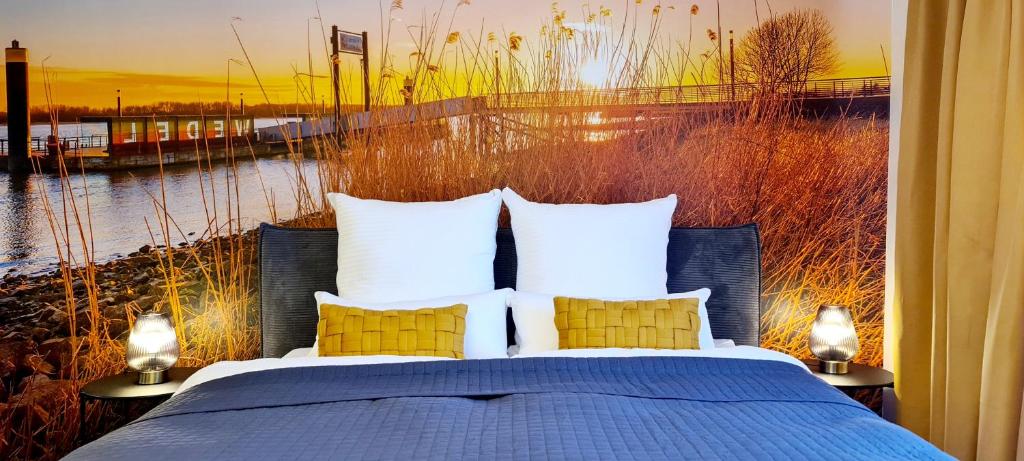 1 dormitorio con 1 cama y vistas al río en ELBQUARTIER | Ferienwohnung in Wedel en Wedel