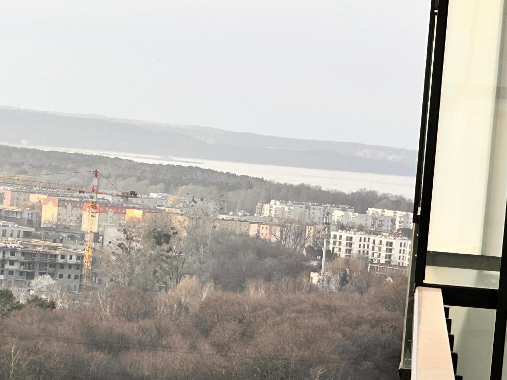 a view of a city from a building at 16 Floor nad morzem - prawy in Gdańsk