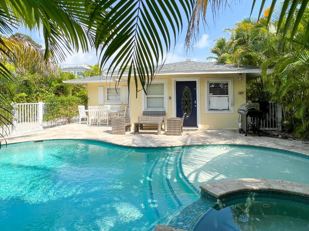 a swimming pool in front of a house at Lazy Days in Sarasota