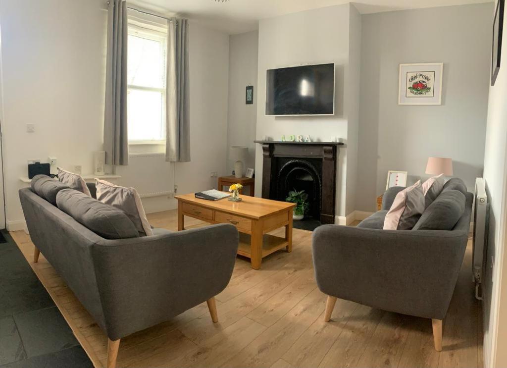 a living room with two couches and a table at Taitwt2 in Caernarfon