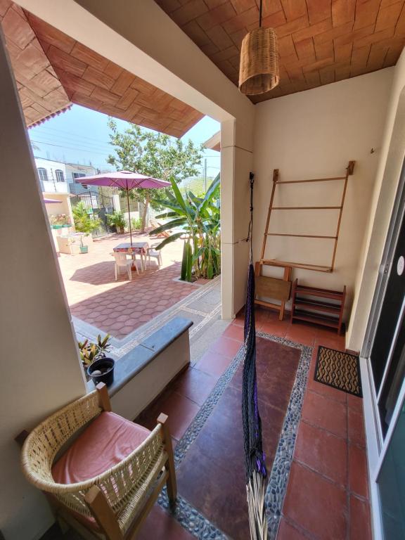 a porch with a hammock and a patio at Casa Puerto Bonito & Private Coworking in Puerto Escondido