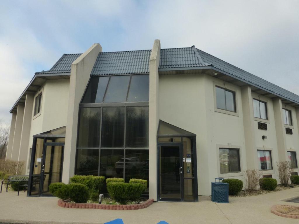 a large white building with a large glass door at Red Roof Inn Greencastle South - Cloverdale in Cloverdale