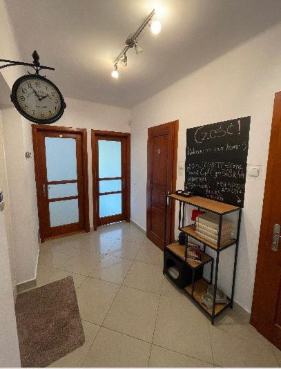 a room with a chalk board and a clock on the wall at Cheerful 3 bedroom city house in Krakow
