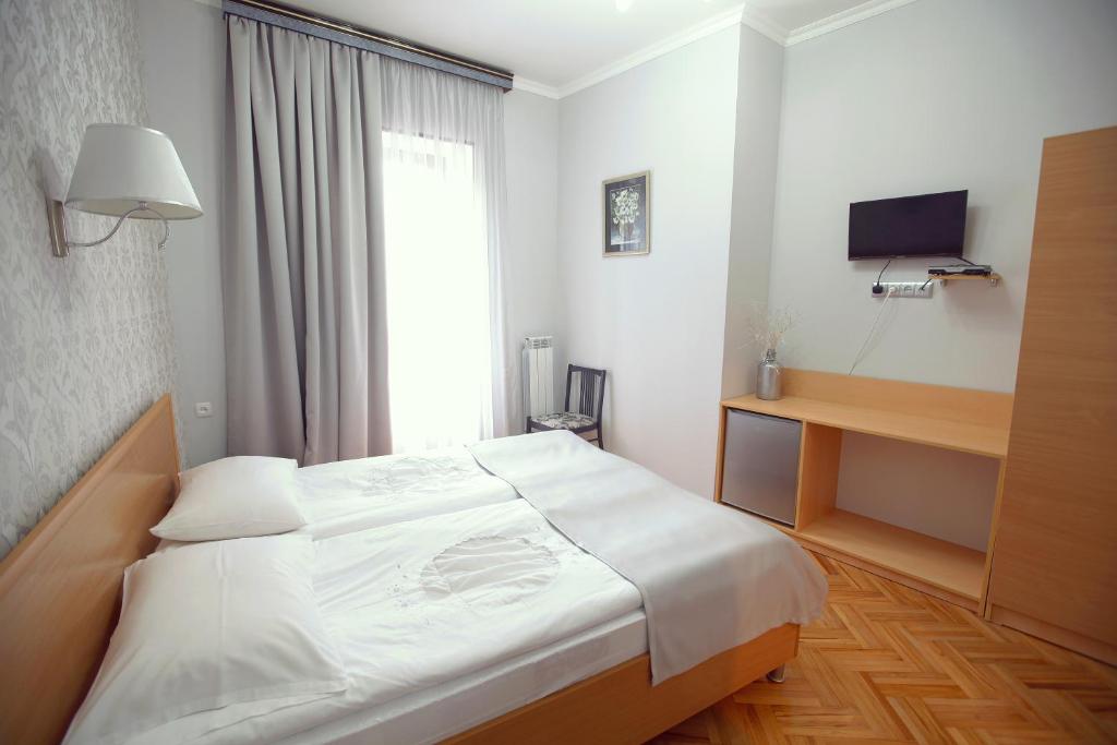 Postel nebo postele na pokoji v ubytování Silver Hotel