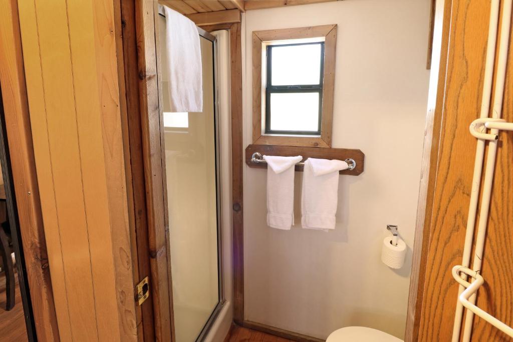 a bathroom with white towels and a window at Sun Outdoors Arches Gateway in Moab