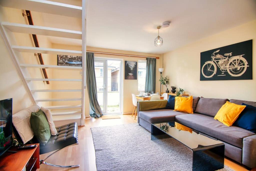 a living room with a couch and a table at 2 Bed Camden Mews in London