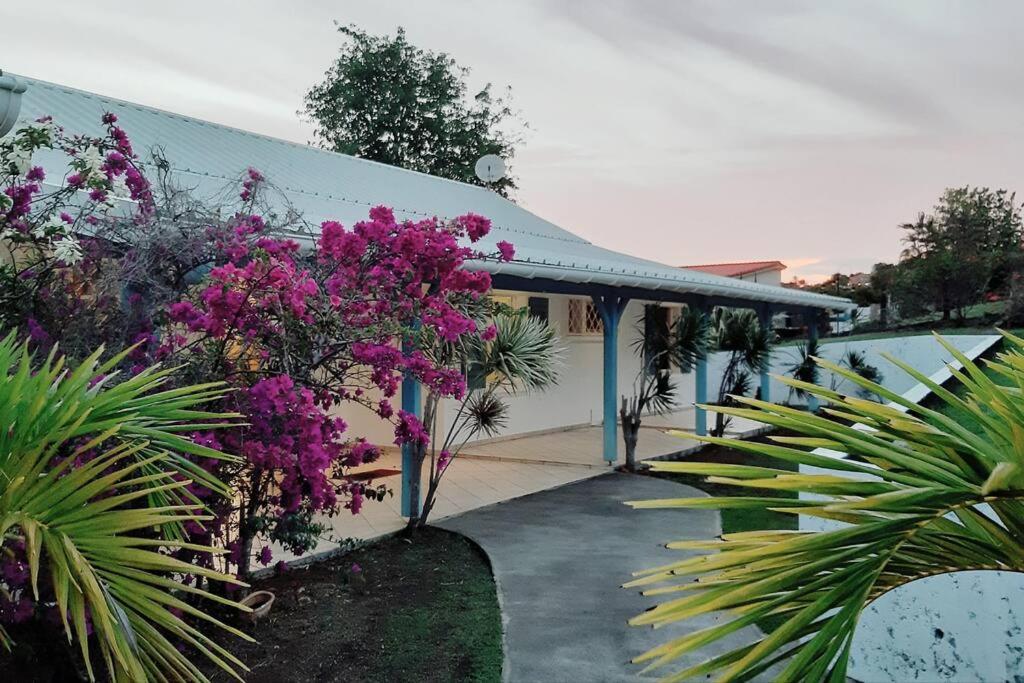 a house with purple flowers in front of it at YOU WELCOME VILLA in Case-Pilote