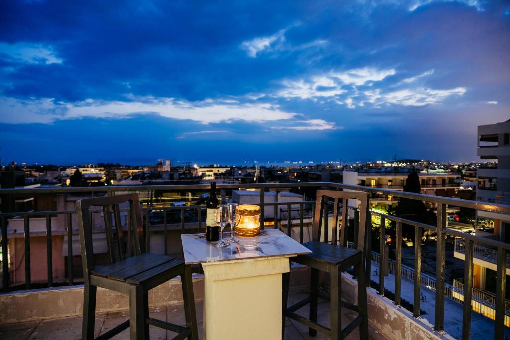 a table and chairs on a balcony with a view at Penthouse of diamond in Athens