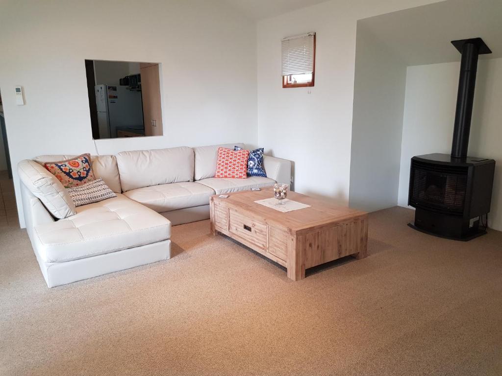a living room with a couch and a wood stove at Lonsdale Shores in Point Lonsdale