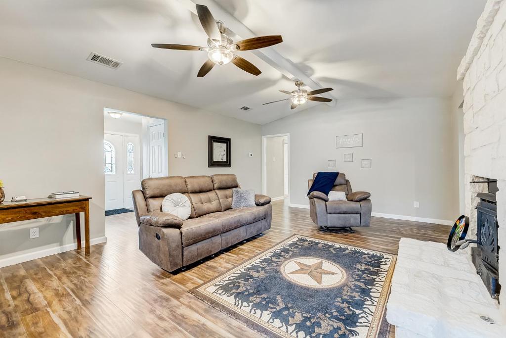 a living room with two couches and a fireplace at Shady Brook Circle in Garland