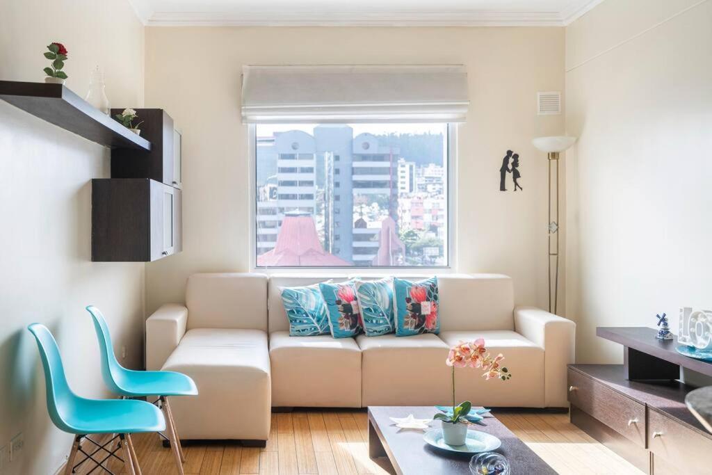- un salon avec un canapé blanc et une fenêtre dans l'établissement Hermosa Suite, siéntete en casa!, à Quito